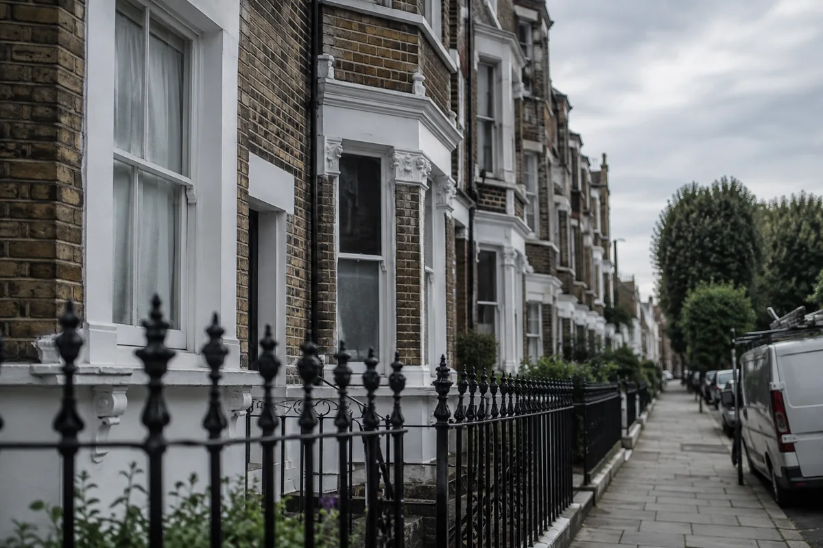 A row of Victorian terraced rental houses in inner London with sash windows and cast-iron railings